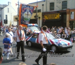 A Car painted in a Union Flag design travels with the parade